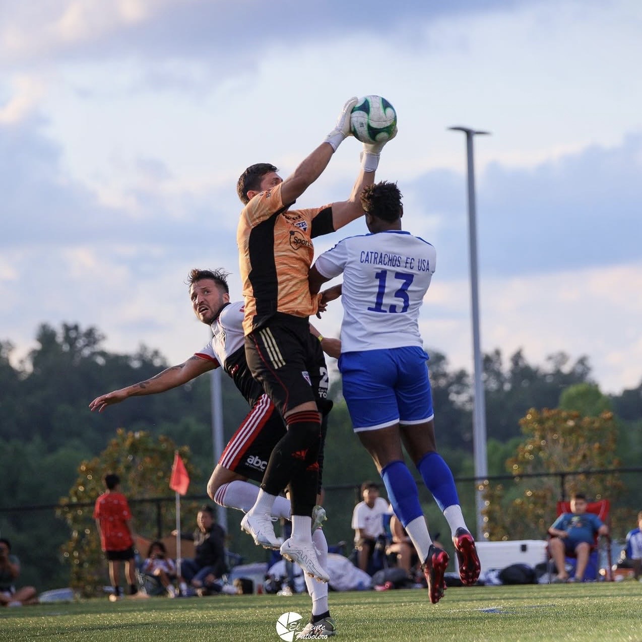 Goalkeeper claims a high ball against Catrachos FC USA